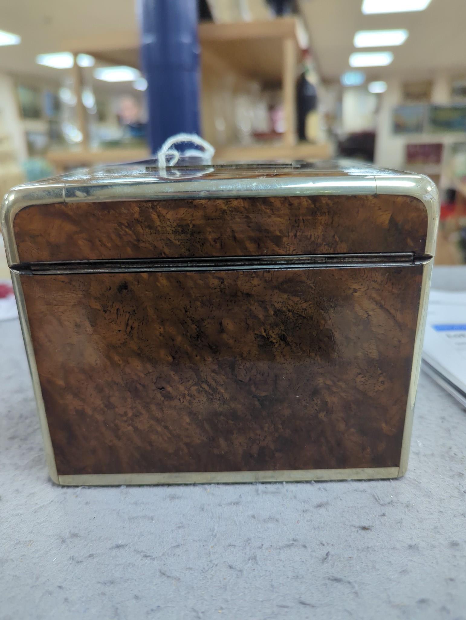 A 19th century Dutch amboyna and brass mounted tea caddy, 14 cm wide and a 19th century French mahogany box by Aucoc Aine a Paris